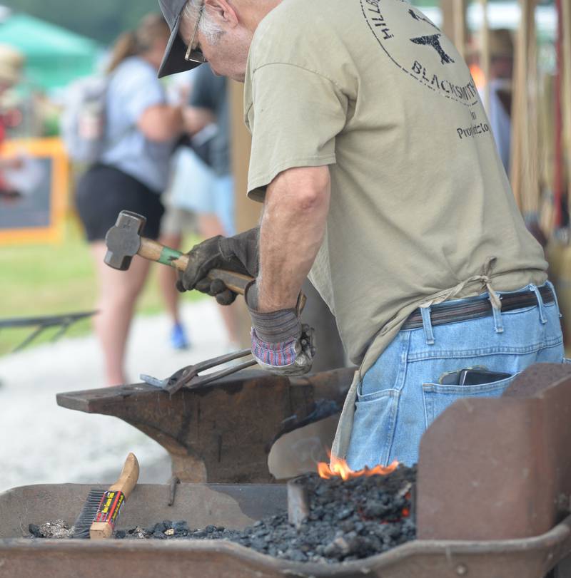 Daryl Drennen of the Hillbilly Blacksmith Shop in Prophetstown, works on a piece at the Bos Brothers Historical Farm on Friday, July 25, 2025.