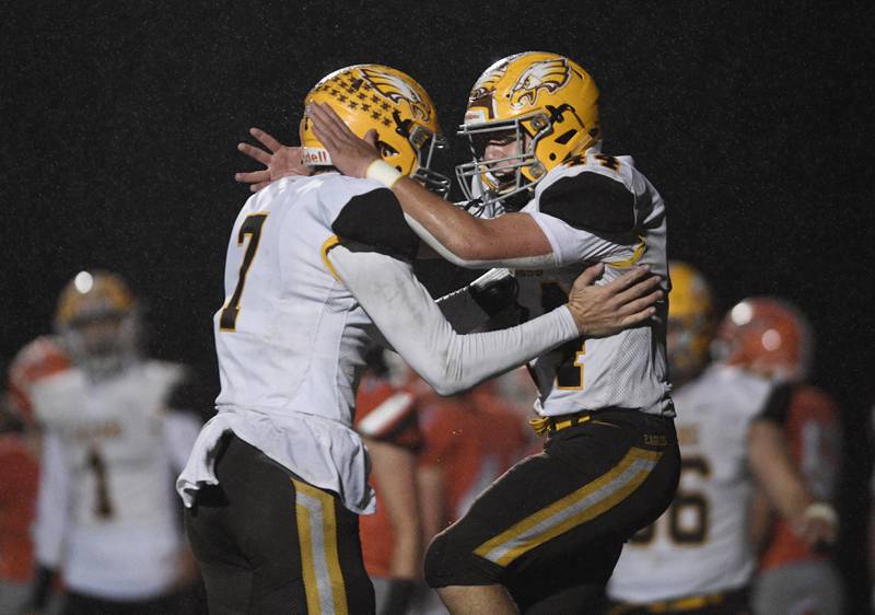 Jacobs' Paulie Rudolph, right, celebrates his touchdown run with teammate Grant Stec in a Class 7A playoff football game in Arlington Heights on Friday, October 29, 2021.