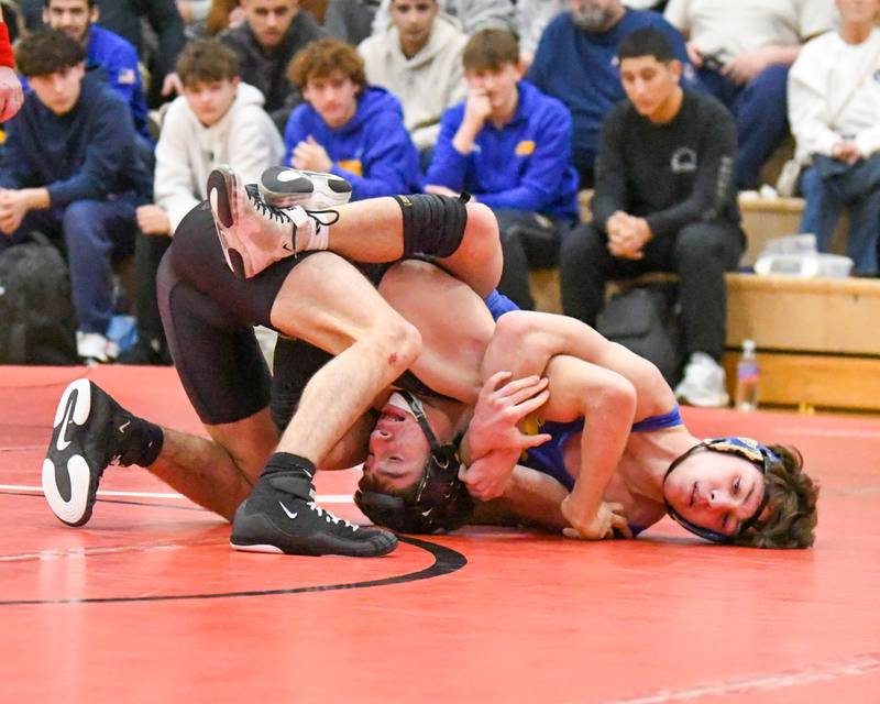 Demetrios Carrera, left, of Marmion Academy keeps a hold of Sandburg wrestler Madden Parker during the 138-weight class during the regional meet on Tuesday Feb. 25, 2025, held at Yorkville High School.