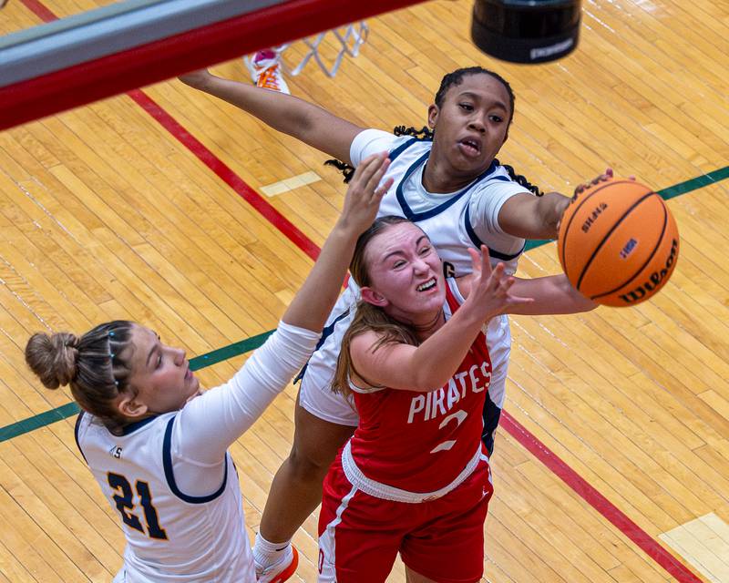 Ashlynn Ganier (2) of Ottawa battles for rebound with Joslyn Green (22) and Jaelynn James (21) of Sterling under basket during Regional Championship game on Thursday, Feb. 19, 2026 in Sellett Gymnasium at L-P High School.