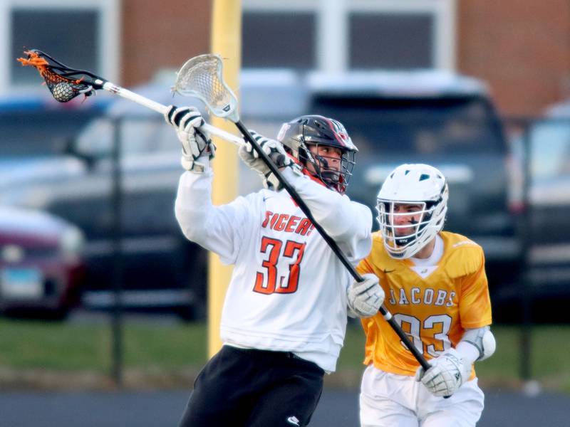 Crystal Lake Central’s Michael Cruz prepares to unload a shot on goal as Jacobs’ Evan Harris defends during varsity lacrosse at Metcalf Field on the campus of Crystal Lake Central Thursday.