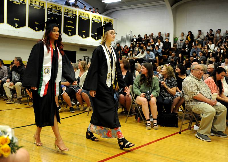 Graduates walks onto the gym Sunday, May 22, 2022, during the Harvard High School Commencement Ceremony in Harvard .