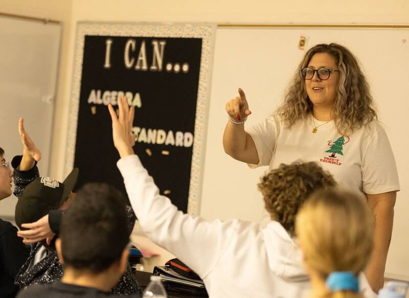 Alyssa Galvan counts her students votes during her 8th grade math class at Kaneland Harter Middle School in Sugar Grove on Monday Dec. 18, 2023. The students voted on which Christmas movie to watch after they completed a math problem at their whiteboards.