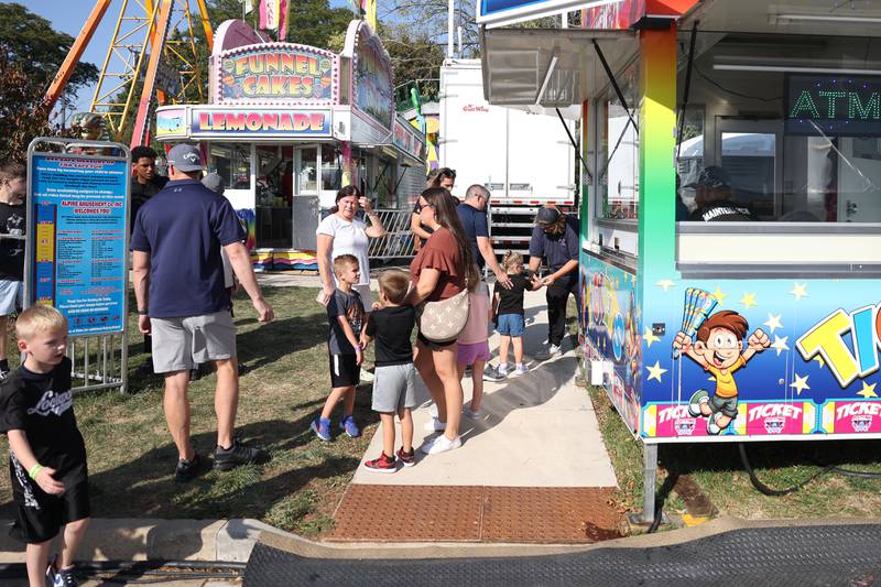 A family buys carnival tickets at the Saint Dennis and Joseph Catholic Academy Annual Oktoberfest on Saturday, Oct. 5, 2024 in Lockport.