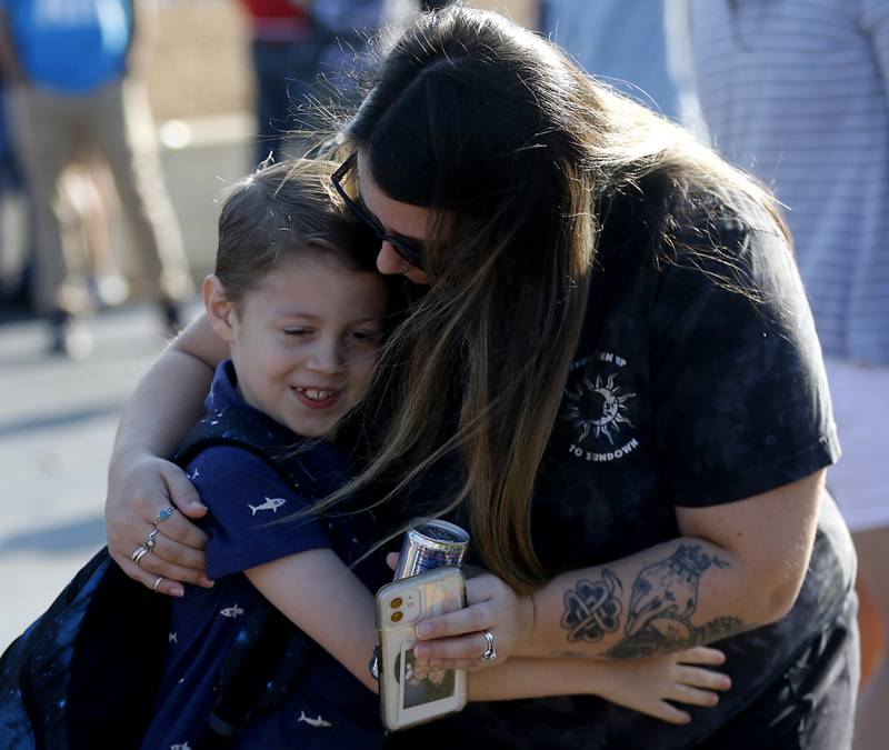 Jameson Parlberg, 7, hugs his mom, Rachel, as she drops him off for the first day of school at West Elementary School in Crystal Lake on Wednesday, Aug. 16, 2023.