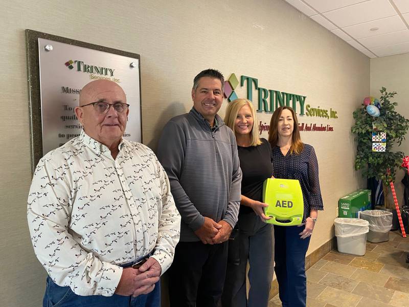 Trinity Services in New Lenox recently received an automated external defibrillator from the Tommy Schuman Foundation. Pictured, from left, are Ray Carmody, director of administrative operations for Trinity; Dan and Lynn Schuman from the Tommy Schuman Foundation; and Sherry Ladislas, director of development for Trinity.