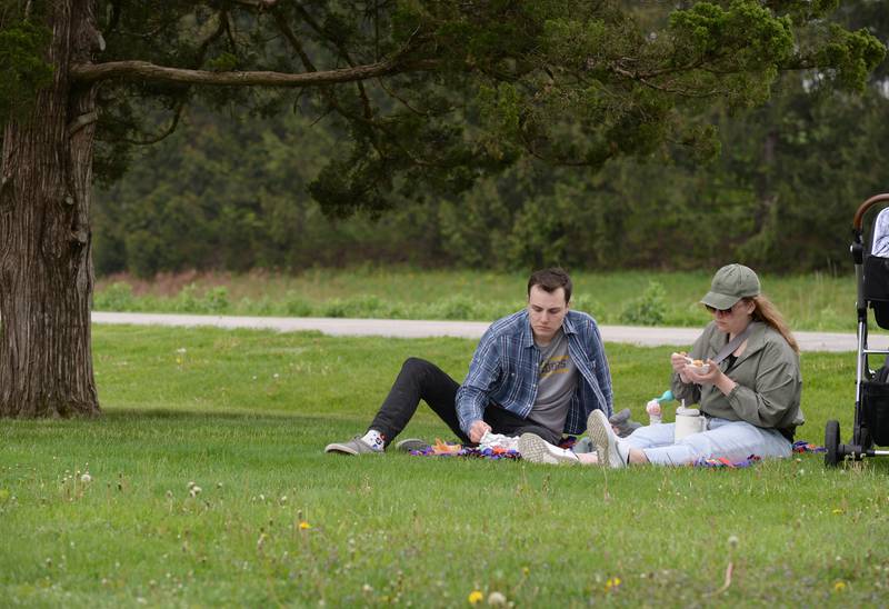 People including Michael and Kelsey Walz of Westmont enjoy a picnic while attending  Cantigny's Spring Fling and Market Saturday May 13, 2023.