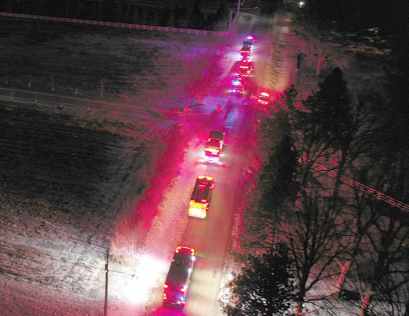 Emergency personnel stage at the scene of a structure fire in the 3000 block of East 550th Road on Saturday, Jan. 31, 2026 in Mendota. The fire started in the chimney area. Fire departments from Troy Grove, Utica, La Salle, Peru, Mendota, and others across the region were dispatched shortly after 10p.m.