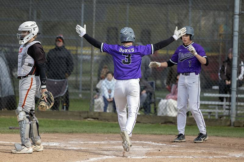 Dixon’s Max Clark comes in to score on a double by Ari Selmani against Byron Monday, May 1, 2023.