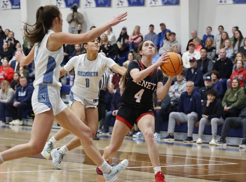Benet's Ava Mersinger (4) goes to the basket during a girls varsity basketball game between Benet and Nazareth academies on Saturday, Dec. 14, 2024 in La Grange Park.