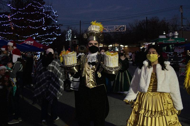 Favorite storybook characters, including Lumiere and Belle, made their way up and down Main Street in downtown Oswego Dec. 3, during the annual Christmas Walk celebration.