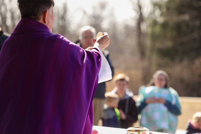 Bishop Chris Glancy, of St. Patrick’s Catholic Church, helps lead a Mass and prayer service held in Aroma Park on Thursday, March 12, 2026, following the EF-3 tornado that tore through the town and Kankakee County on March 10.