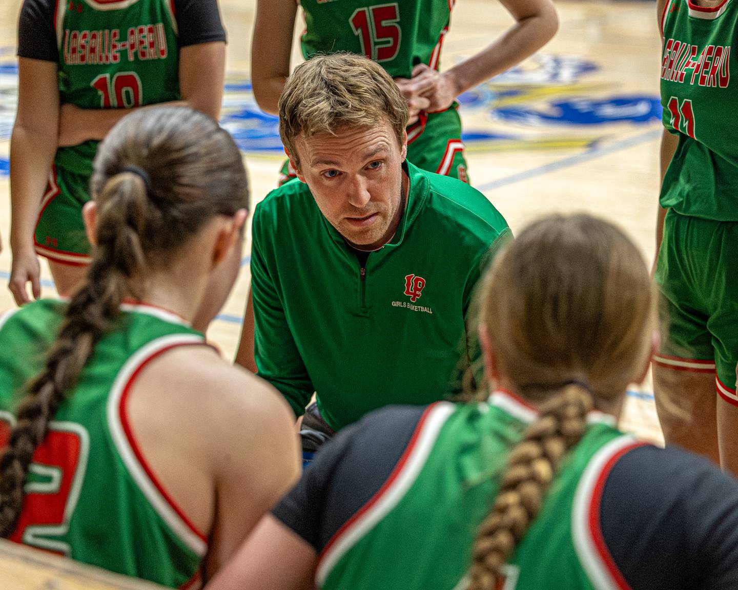LaSalle-Peru Girls Basketball Coach, Adam Spencer talks to team during timeout in game against Marquette Academy on Saturday, January 3, 2026 at Marquette Academy in Ottawa.