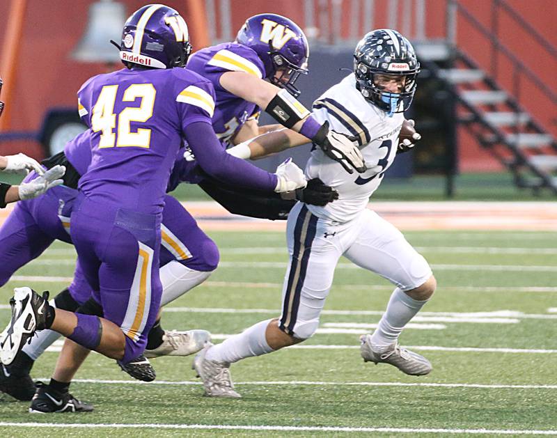 IC Catholic's Joey Gliatta (33) tries to escape Williamsville defenders John Layman (78) and teammate Carson Kohler (42) in the Class 3A State title game on Friday, Nov. 25, 2022 at Memorial Stadium in Champaign.