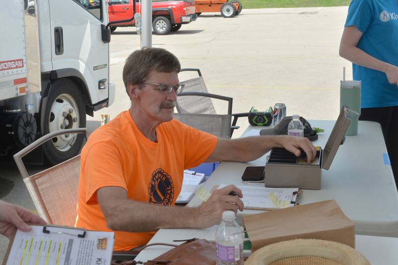 Dixon Kiwanian 'Peach Grand Poobah' Rick Brantner runs the club's distribution day at a Dixon High School parking lot on Thursday, Aug. 10.
