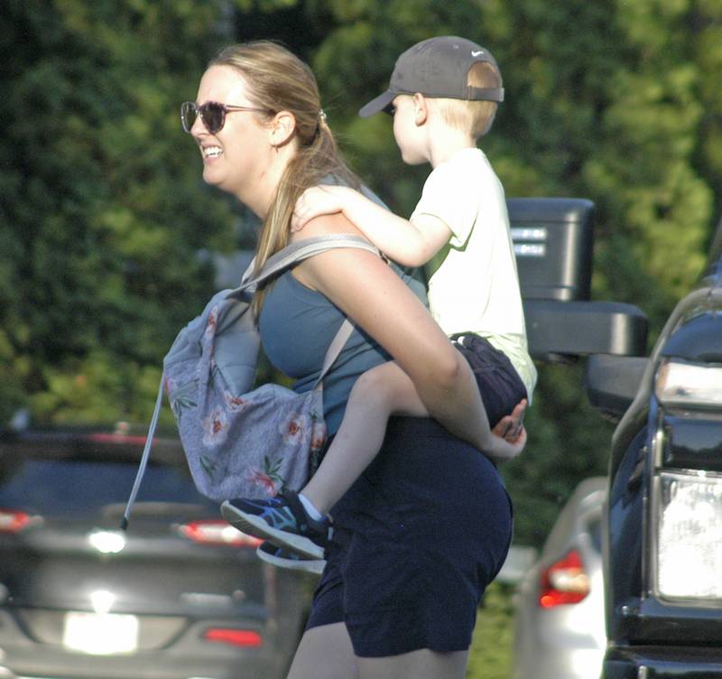 A loaded-down Reagan Run contestant makes her way to the starting line Saturday, July 5, 2025, in Dixon.