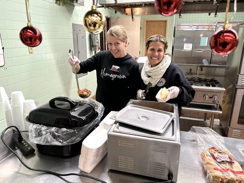 Julia Krogman (left) and Maria Whitehead were busy serving up chili and hot dogs in the cafeteria of the Forreston Grade School during Christmas in the Country on Friday, Dec. 5, 2025.