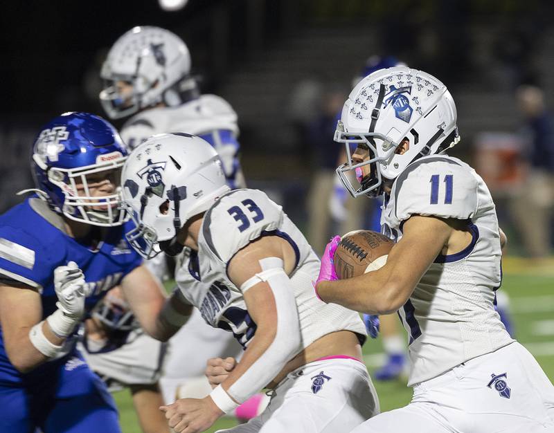 Monmouth-Roseville’s Payton Thompson picks up yards against Newman Friday, Oct. 25, 2024, at Roscoe Eades Stadium in Sterling.