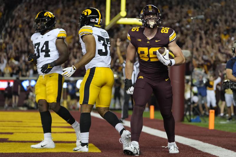 Minnesota tight end Jameson Geers (86) celebrates after catching a three-yard touchdown pass during the first half of an NCAA college football game against Iowa in Minneapolis. (AP Photo/Abbie Parr)