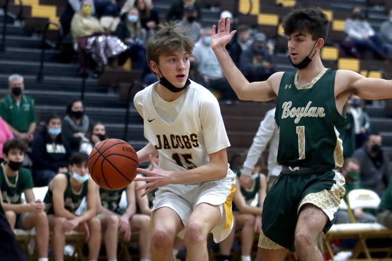 Jacobs’ Carter Roper moves with the ball past Boylan’s Austin Hocking, right, during boys varsity basketball against Rockford Boylan at Algonquin Saturday afternoon.