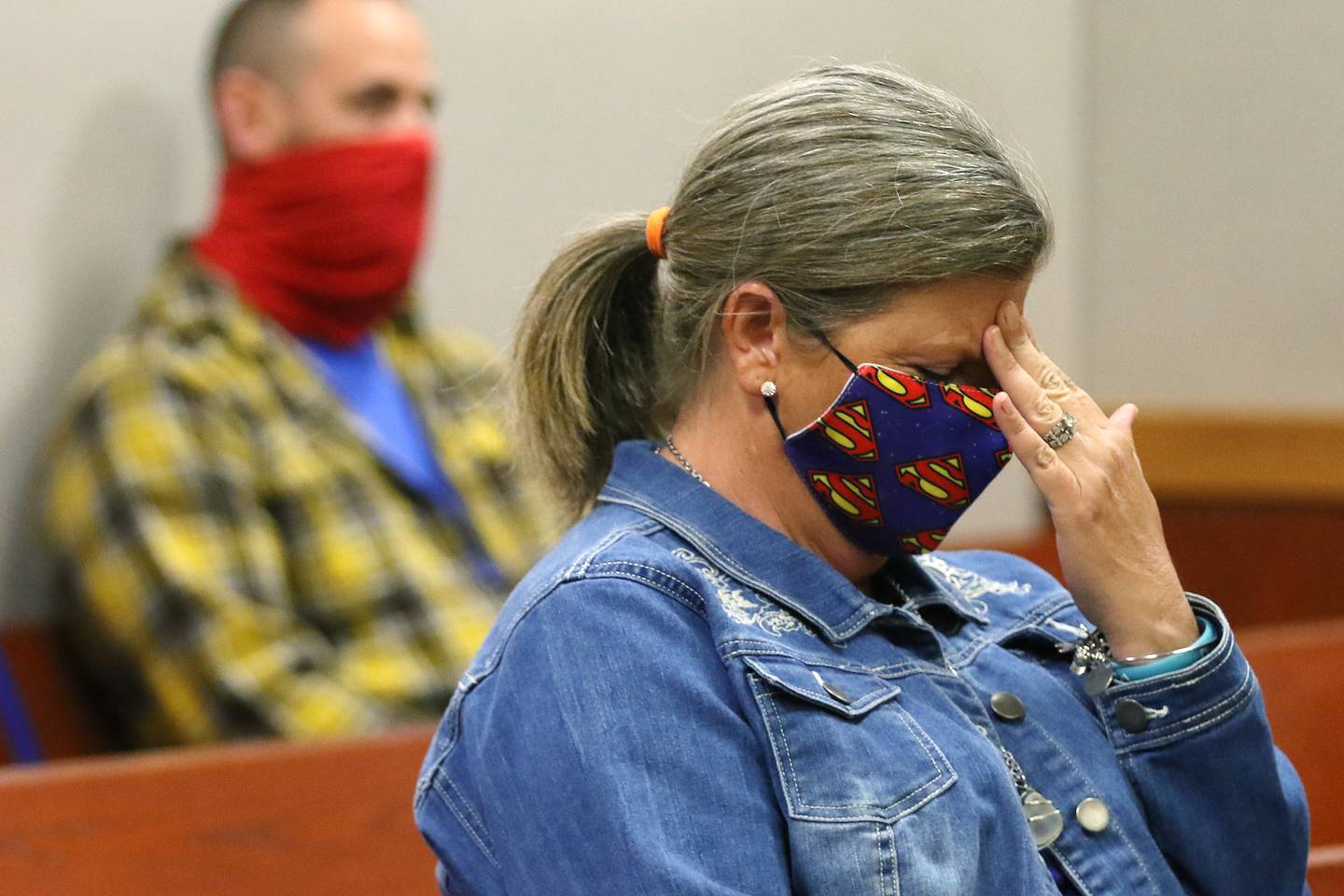 Roar for AJ founder Tracy Kotzman holds her head in her hand as State's Attorney Patrick Kenneally reads from documents detailing the abuse that preceded Crystal Lake 5-year-old AJ Freund's death during a guilty plea deal and sentencing for AJ's father, Andrew Freund, with attorney Hank Sugden inside Judge Robert Wilbrandt's courtroom at the Michael J. Sullivan Judicial Center, formerly known as the McHenry County Courthouse, on Friday, Sept. 18, 2020, in Woodstock.  Freund pled guilty to multiple charges related to the death of his 5-year-old son AJ in March 2019 and will serve 30 consecutive years for the charges.