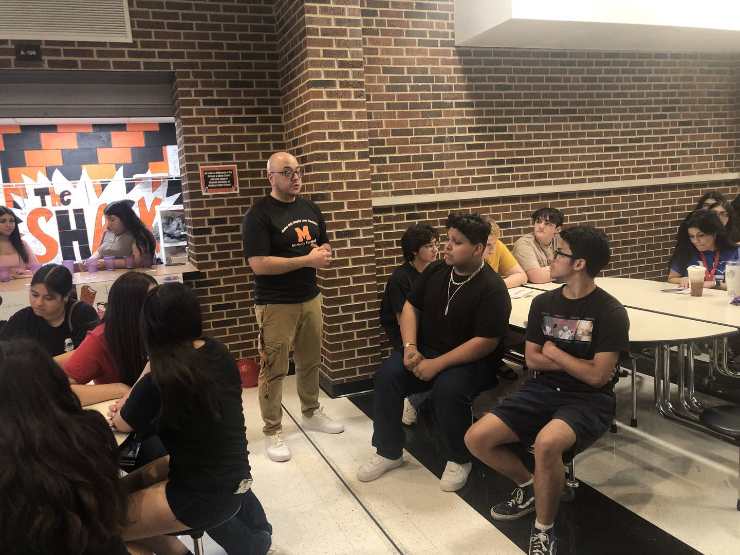 Otto Corzo, standing, teachers Spanish at McHenry High School and is the Latin American Student Organization advisor. Students across the district were invited to the first-ever Latin X-Perience career and cultural event, held Friday, April 14, 2023.