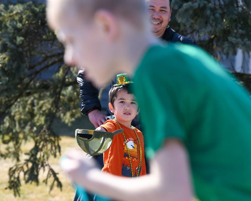 Owen Tran, 5, of Countryside holds out his hat in preparation for candy during the Countryside St. Patrick’s Day parade held on Saturday March 1, 2024.