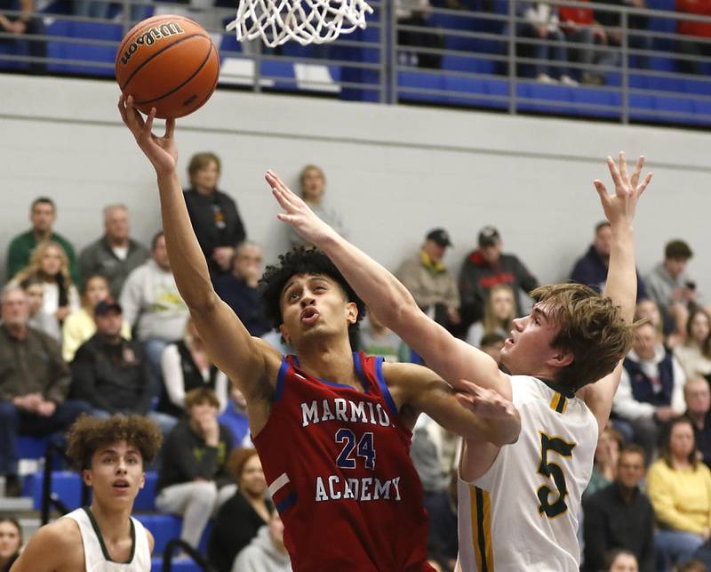 Marmion’s Trevon Roots shoots the ball around Crystal Lake South's Brady Schroeder  during a IHSA Class 3A Sectional boys basketball game Tuesday, Feb. 28, 2023, at Central High School in Burlington.