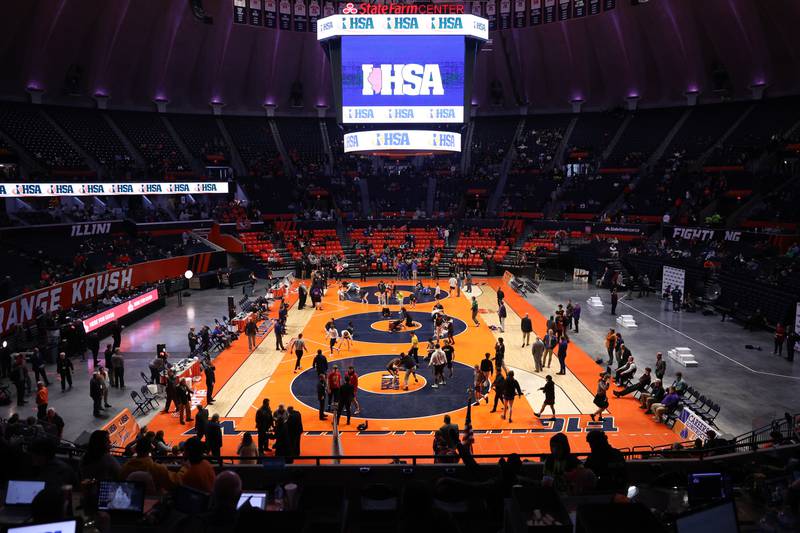 Wrestlers warm up before the championship matches on Saturday, Feb. 18, 2023 at State Farm Center in Champaign.
