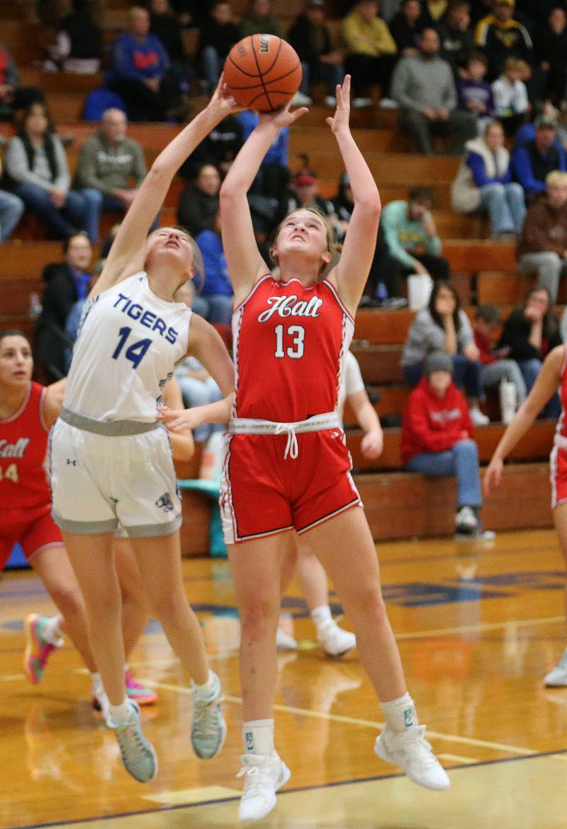 Princeton's Payton Brandt and Hall's Caroline Morris tip the ball in the air during the Princeton Holiday Girls Basketball Tournament on Friday, Nov. 23, 2024 at Princeton High School.