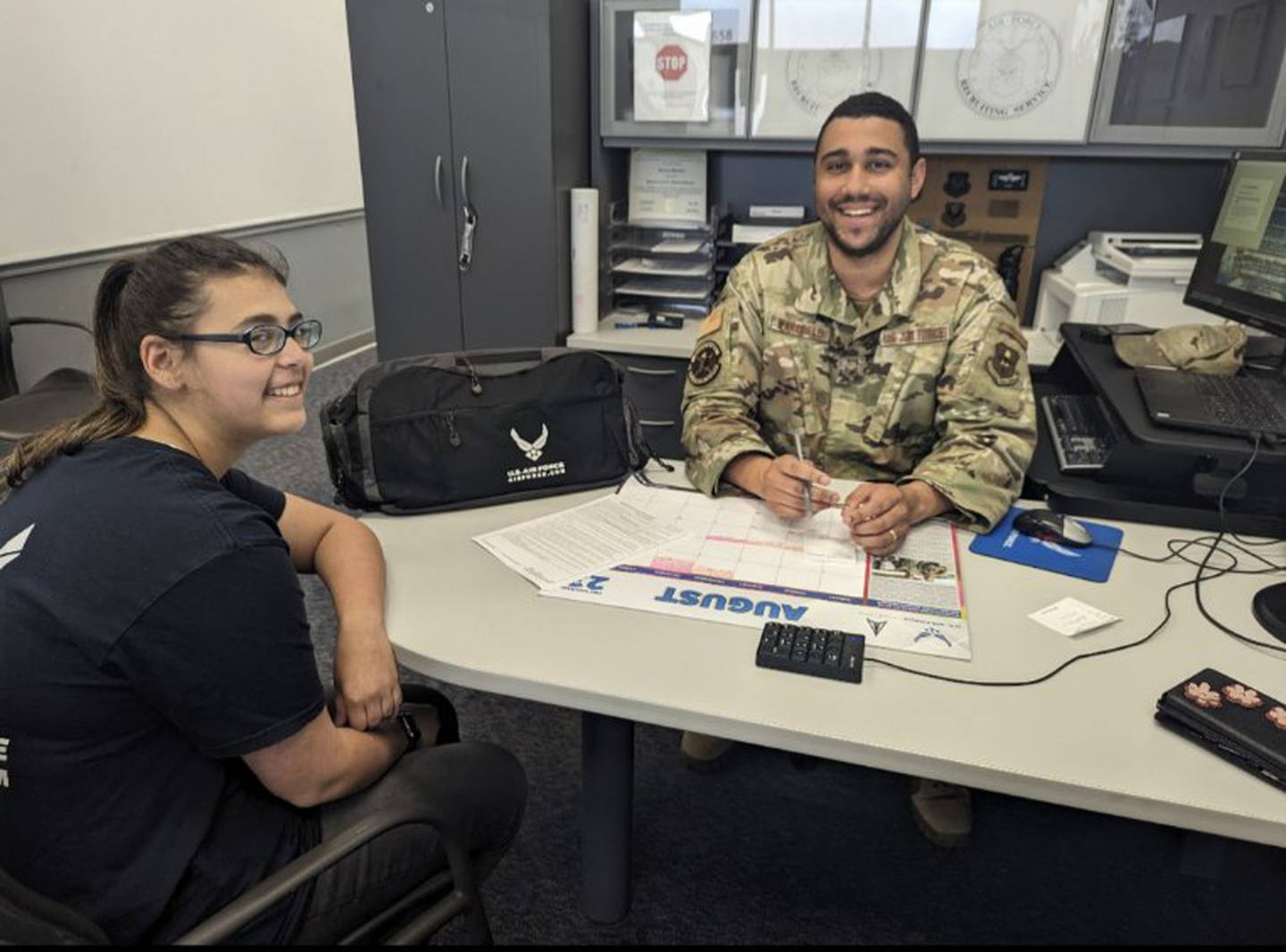 Madeline Bauman sits with her U.S. Air Force recruiter. She is now in basic training in Texas.