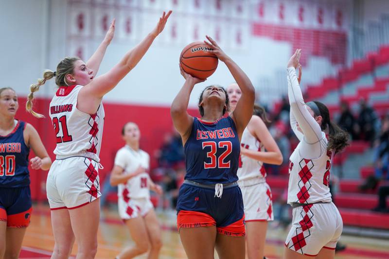 Oswego’s Ahlivia East (32) plays the ball in the post against Naperville Central during a basketball game at Naperville Central High School on Friday, Nov 17, 2023.