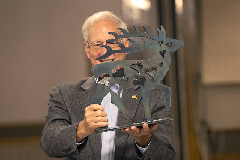 Dixon mayor Glen Hughes displays a gift from Herzberg/Elster Burgermeister Karsten Eule-Pruze at a dinner Thursday, July 25, 2024 celebrating 25 years of being Sister Cities. Twenty-four delegates from the German town are currently visiting Dixon.