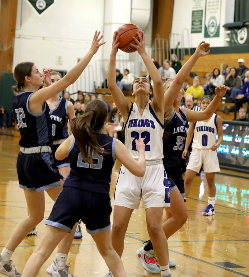 Geneva’s Leah Palmer (center) pulls down a rebound during a Class 4A Glenbard West Sectional semifinal game against Lake Park in Glen Ellyn on Tuesday, Feb. 21, 2023.