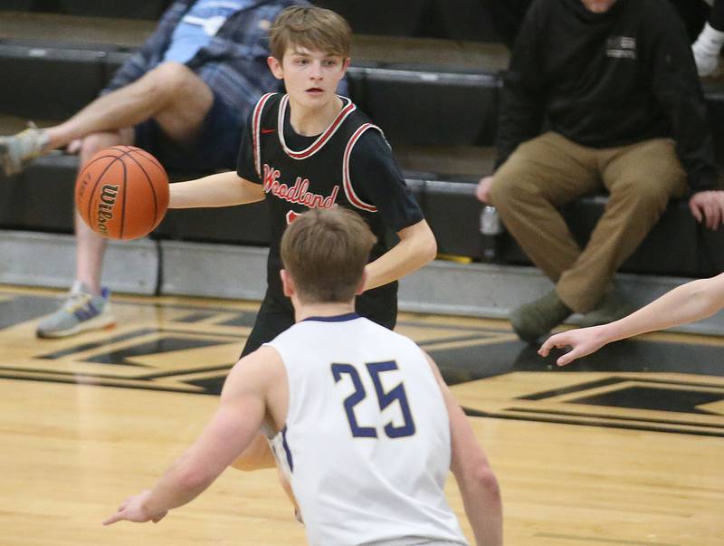 Woodland's Tucker Hill looks to pass the ball around Marquette's Peter McGrath during the Tri-County Conference Tournament on Thursday, Jan. 25, 2024 at Putnam County High School.