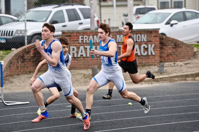 PHS' Keegan Fogarty takes the baton from teammate Ethan in Monday's Howard-Monier Invitational at Princeton. The Tigers won both the 4x100 and 4x200 relays.
