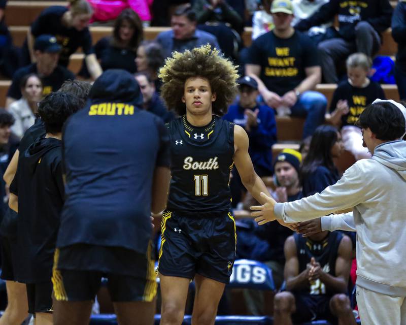 Hinsdale South's Ayden Farrare (11) is introduced before basketball game between Hinsdale South at Downers Grove South. Dec 1, 2023.