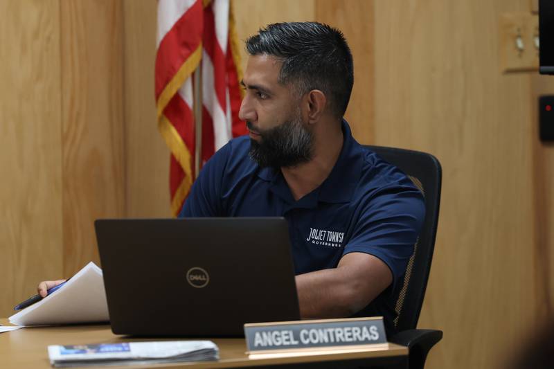 Angel Contreras talks with fellow trustees before the Joliet Township meeting on Tuesday, July 11th, 2023 in Joliet.