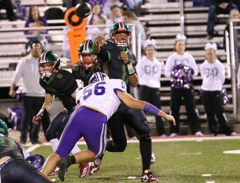 L-P quarterback Marion Persich gets rid of the ball as Rochelle's Ryan Senne puts pressure on him on Friday, Sept. 27, 2024 at Howard Fellows Stadium.