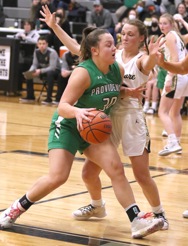 Providence Catholic's Megan Duzansky tries to get through the defense of Sycamore's Ella Shipley during their game Tuesday, Feb. 22, 2022, in the Class 3A Kaneland sectional in Maple Park.