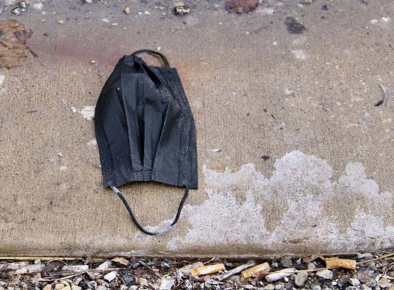 A face mask lays discarded Wednesday on the sidewalk outside KSB Hospital's Emergency Entrance on First Street in Dixon, the same day that Gov. JB Pritzker announced he would provisionally lift the masking mandate for the state on Feb. 28.