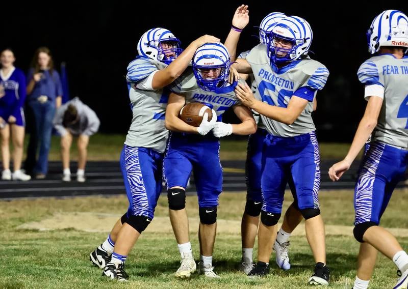 Princeton freshman Reece Pearson is congratulated by teammates after his 9-yard touchdown in the TIgers' 63-12 win over Kewanee on Friday.