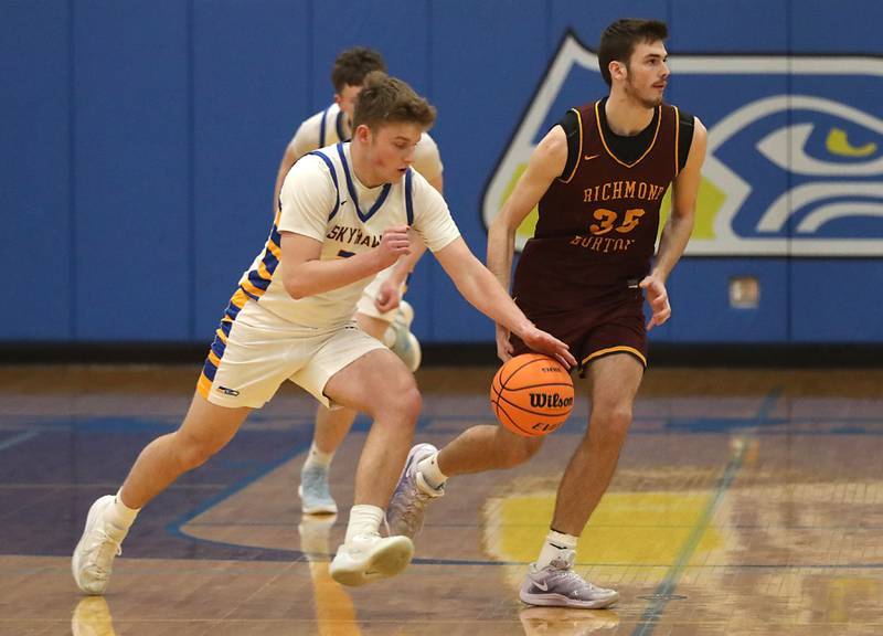 Johnsburg's Jayce Schmitt steals the ball from Richmond-Burton's Jace Nelson during the IHSA Class 2A Johnsburg Regional Championship boys basketball game on Friday, February, 27, 2026, at Johnsburg High School.