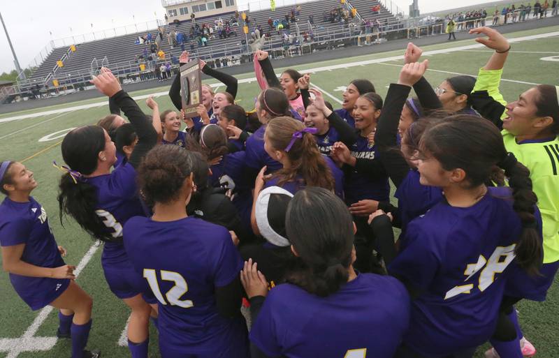 Members of the Mendota girls soccer team hoist the Class 1A Regional final plaque after defeating Princeton on Tuesday, May 20, 2025 at Mendota High School.