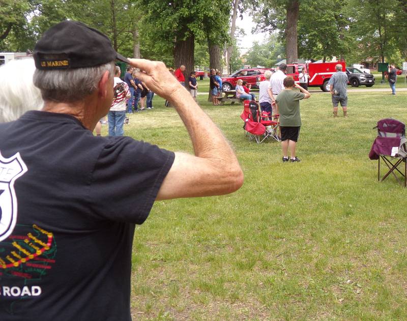 Residents salute as Taps is played by Tom Rice on Monday, May 29, 2023, during the Memorial Day ceremony at City Park in Streator.