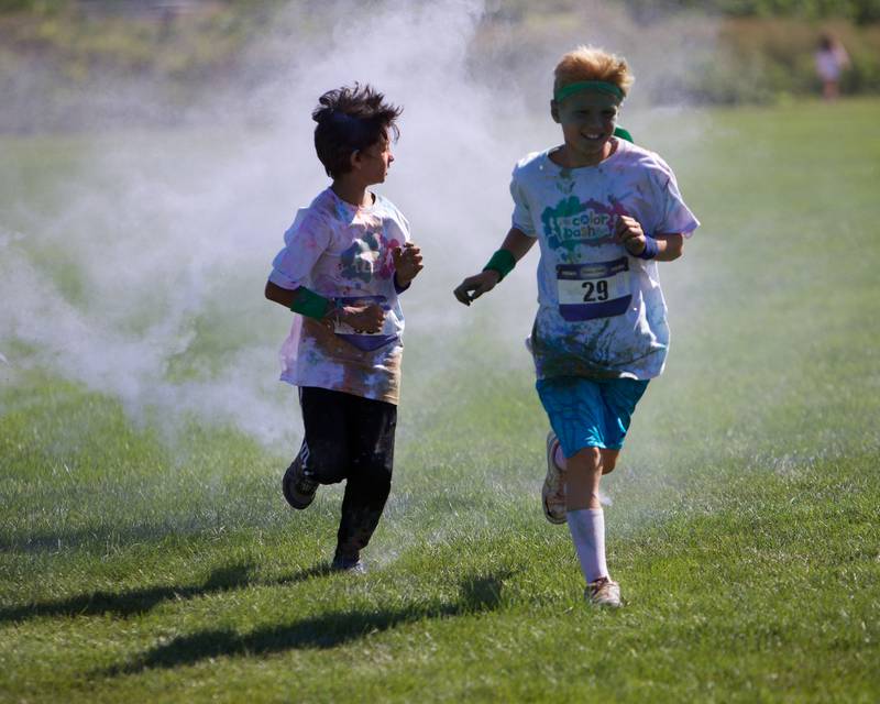 Kids run through the colors at the Glen Ellyn 2K Kids Color Bash Run on Saturday Aug.10, 2024 at Ackerman Park in Glen Ellyn.