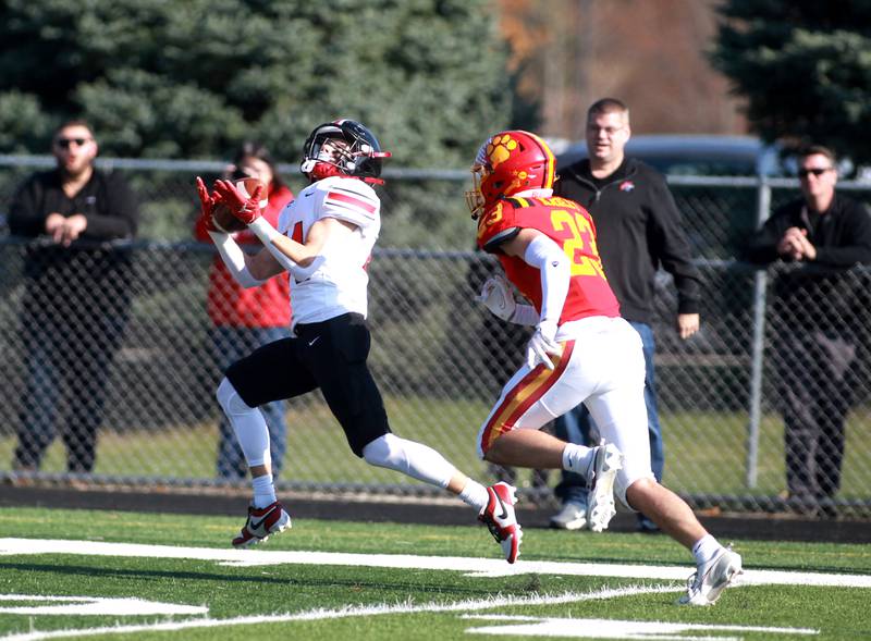 Lincoln-Way Central’s Jimmy Herget catches the ball for a touchdown as he’s chased by Batavia’s Josh Kahley during the Class 7A second round playoff game in Batavia on Saturday, Nov. 4, 2023.