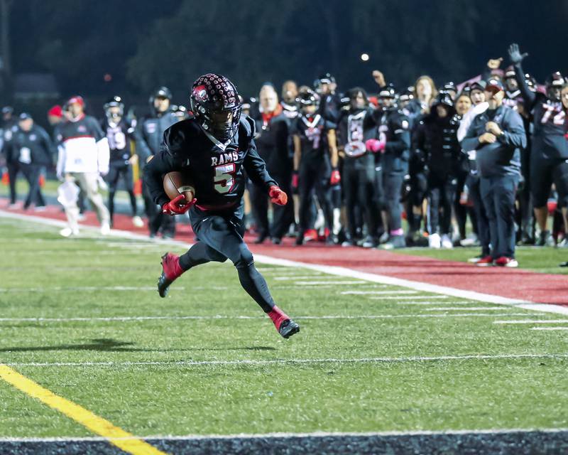 Glenbard East's Donte Hudson (5) runs in a touchdown during football game between Glenbard South at Glenbard East.   Oct 13, 2023.