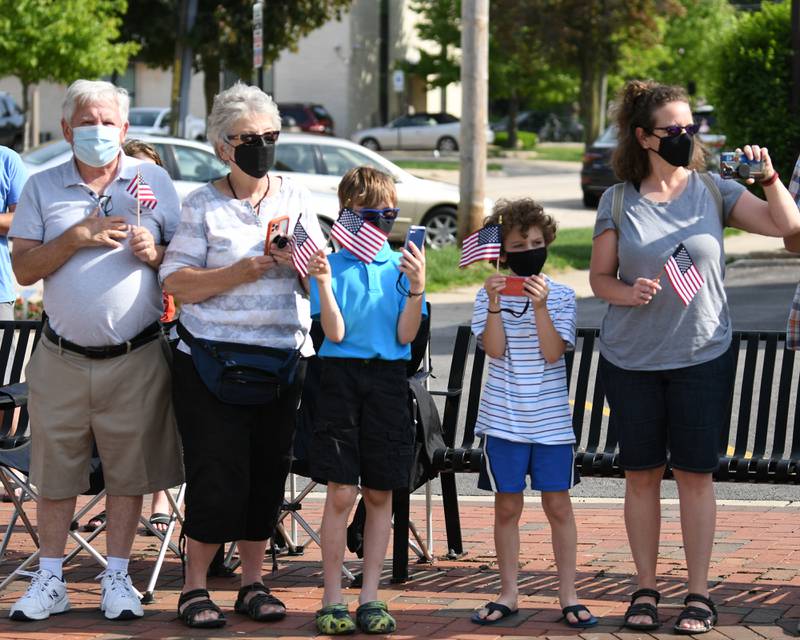 Mother Maria Barnes, right, Son Matthew, 7, Joshua, 10, and parents Linda and Jon Whipple all from Courtland watch and record the start of the DeKalb's Memorial Day parade held on Monday May30th.