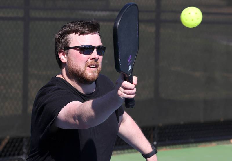 Trevor Ruback, from DeKalb, plays pickleball Friday, June 14, 2024, on the new courts at Hopkins Park. The park district was hosting a Dedication Celebration event at the park for the grand opening of the new playground and racquet courts.